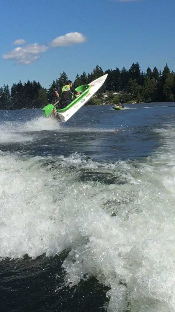 Green and white boat on the lake geting air Nanaimo Festivals events and family fun