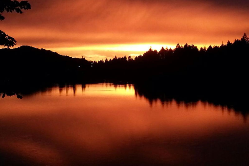 Beautiful orange sunset reflecting on Nanaimo Lake