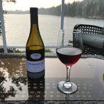 Stoneleigh bottle of wine and wine glass on table overlooking lake Nanaimo, BC