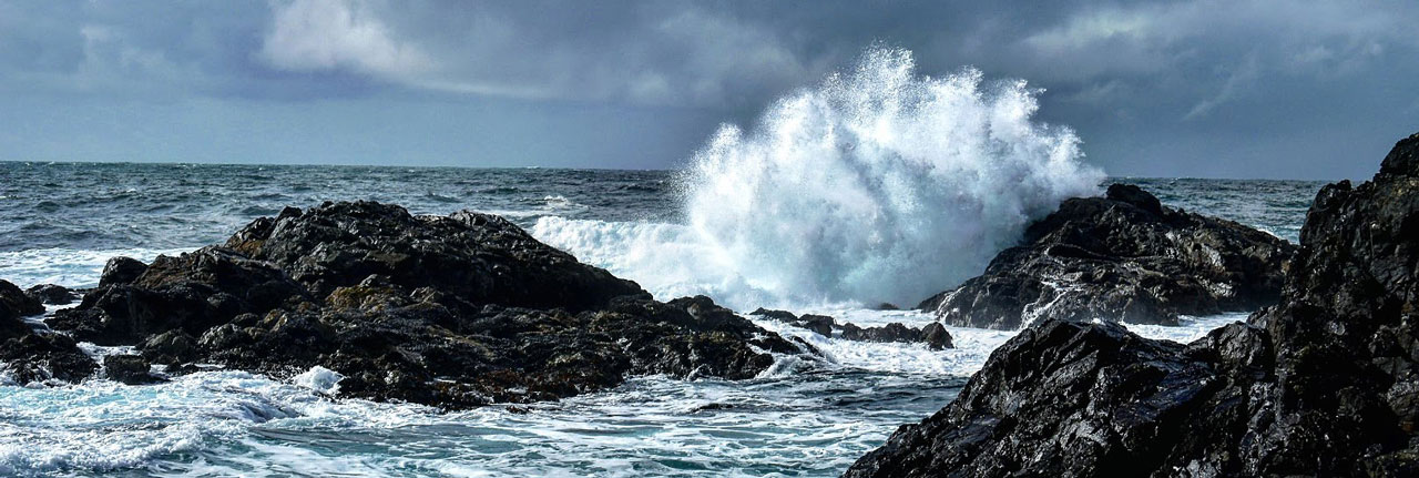 Large wave crashing on rock west coast Canada