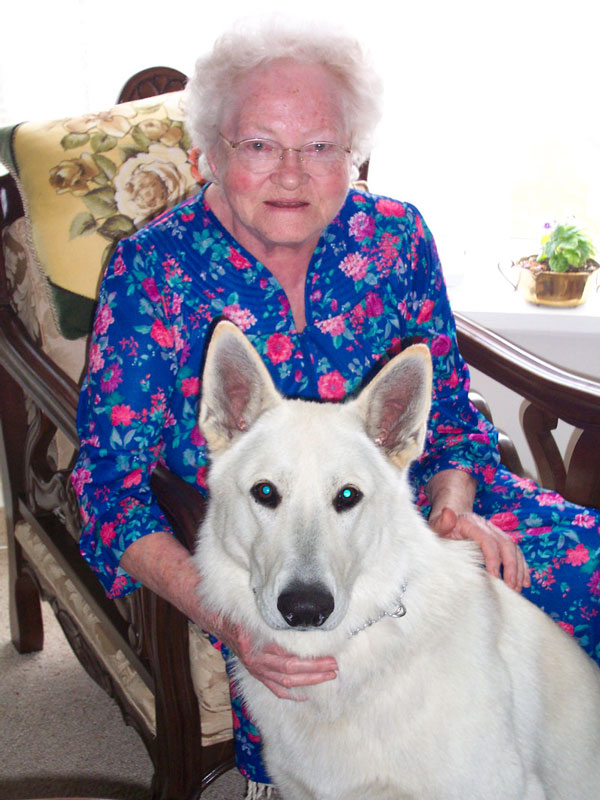 Senior citizen with white dog